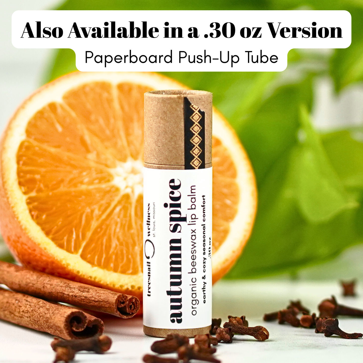 Lip balm with cinnamon sticks and an orange in the background