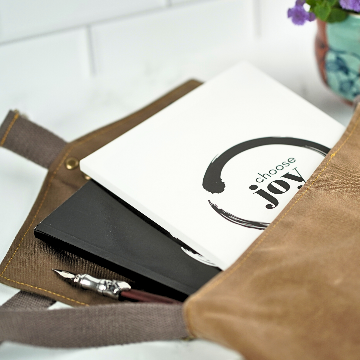 The Choose Joy Affirmation Journal by Treesnail Wellness comes with a choice of either a white or black cover.