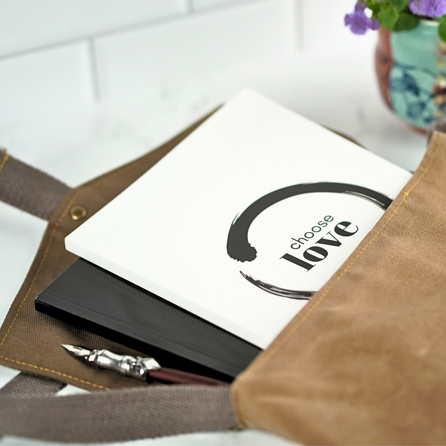 The Choose Love Affirmation Journal by Treesnail Wellness comes with a choice of either a black or white cover.