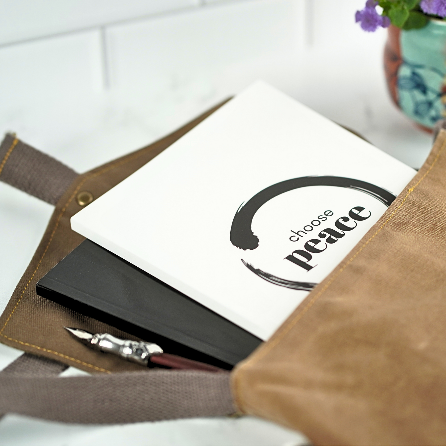 The Choose Peace Affirmation Journal by Treesnail Wellness comes with a choice of either a black or white cover.