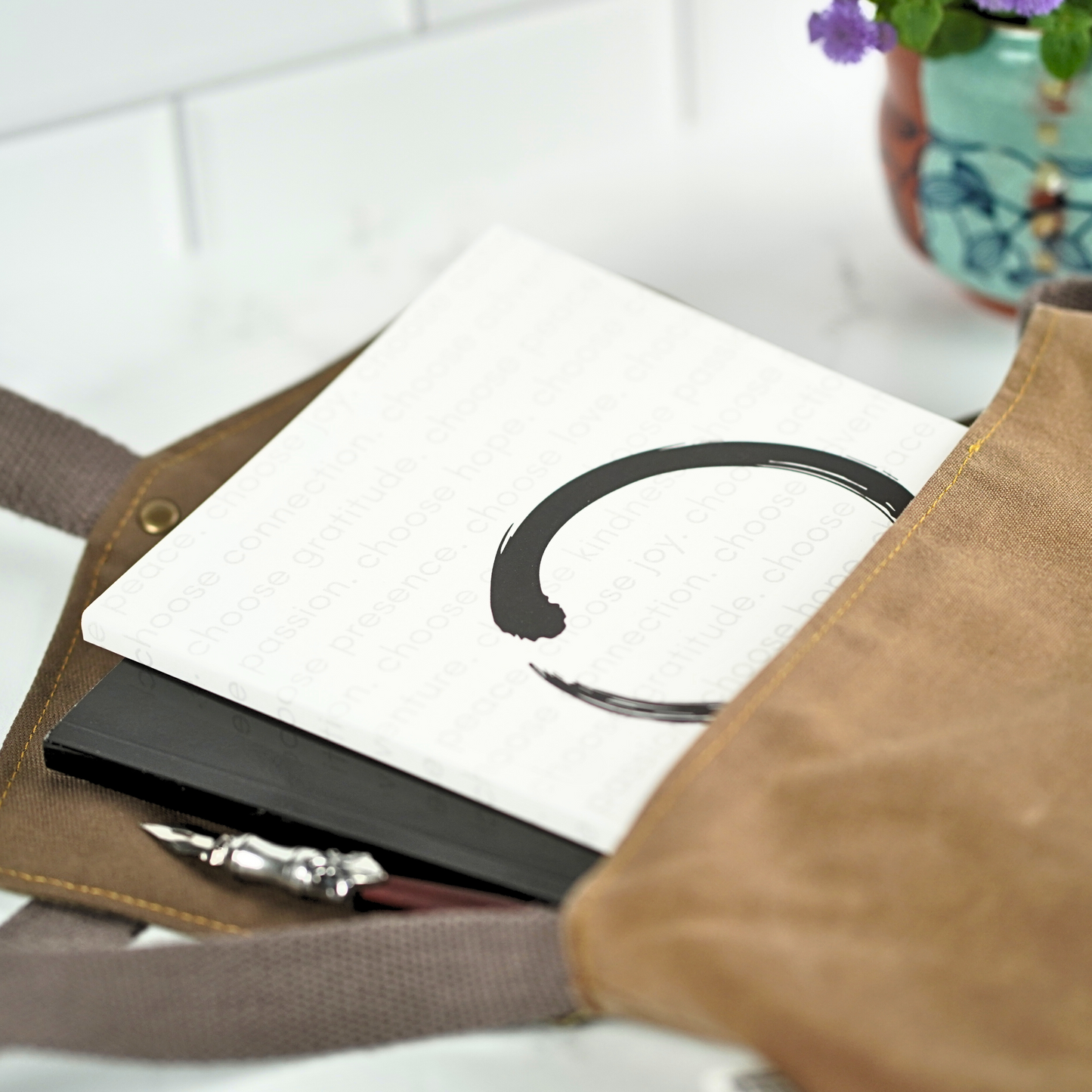 The Enso Circle Affirmation Journal by Treesnail Wellness comes with a choice of either a black or white cover.