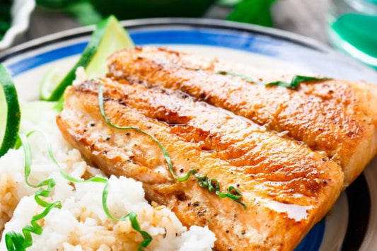 Chili Lime Baked Trout on a plate with rice and lime