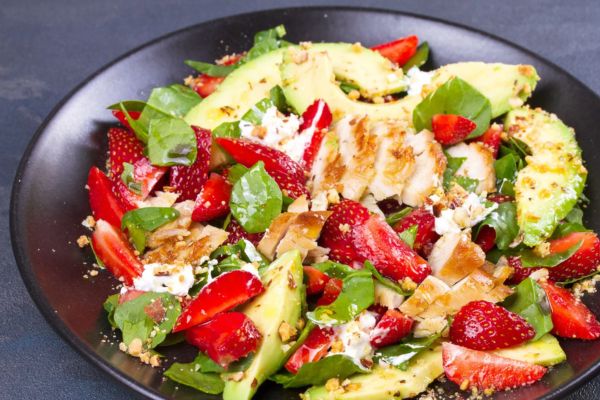Salad with grilled chicken, strawberries, avocado, nuts