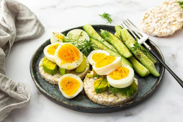 Hard boiled eggs, avocado, rice cake