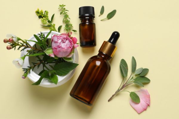 face serum bottles next to roses