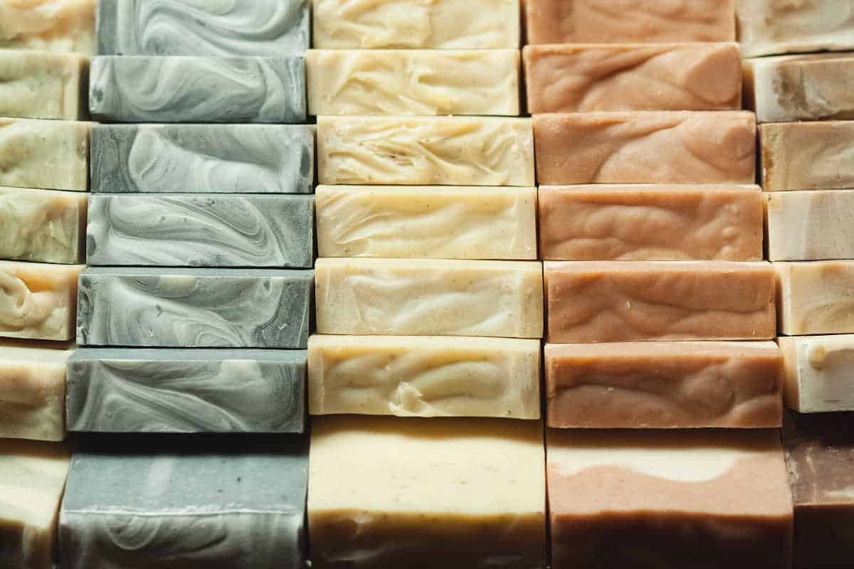 tops of natural soap bars in a variety of colors stacked together