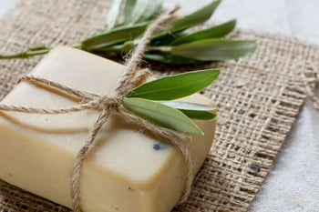 bar of soap tied with natural string and a bundle of sage on top