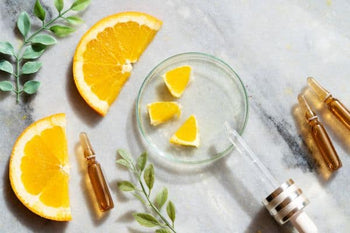 orange slices and plant next to a tray with oils and a pipette