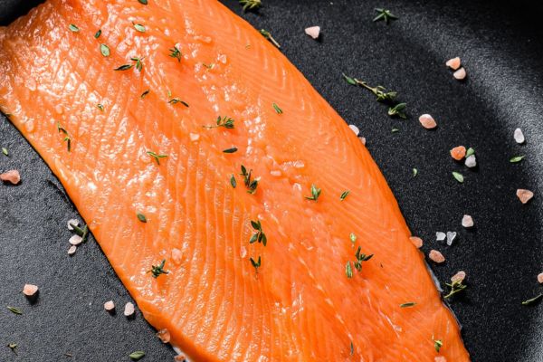trout in pan with salt and herbs
