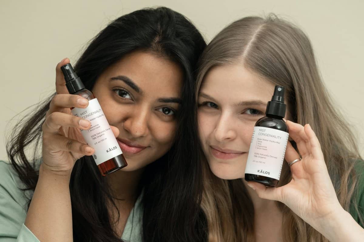 Two women holding skincare products