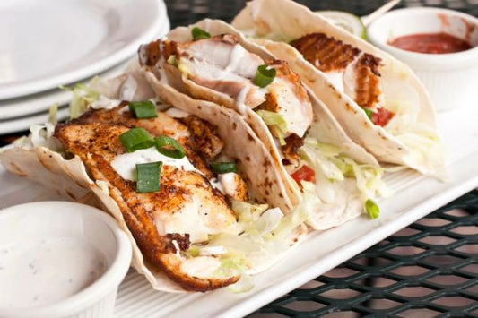 tilapia inside flour tortillas with lettuce and chives