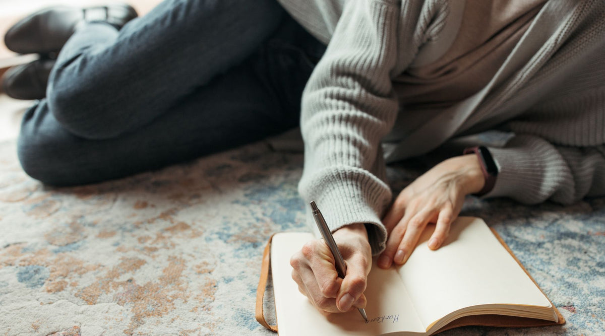 Woman writing in an affirmation journal