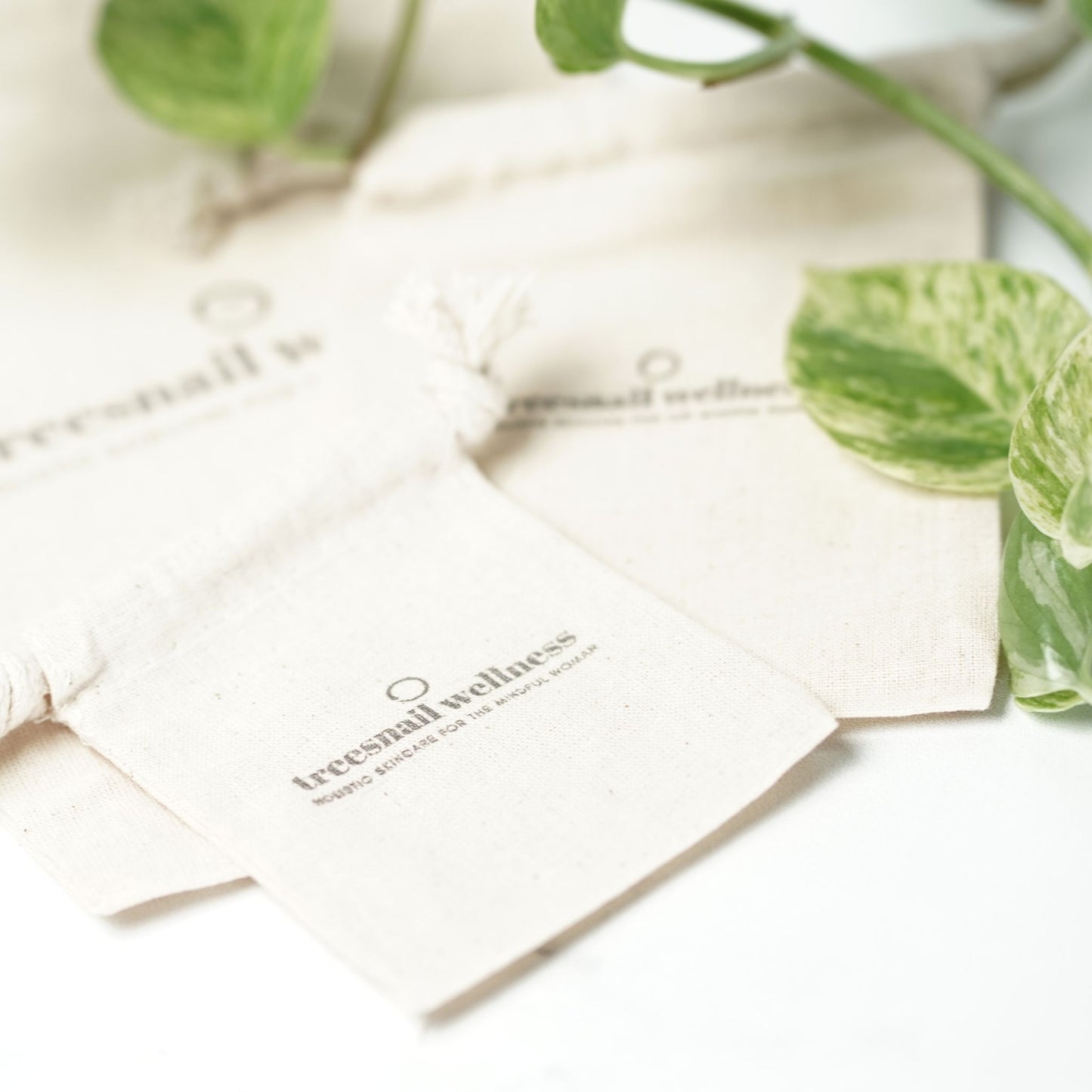 Sustainable cotton muslin bag packaging option for Treesnail Wellness natural skincare products.