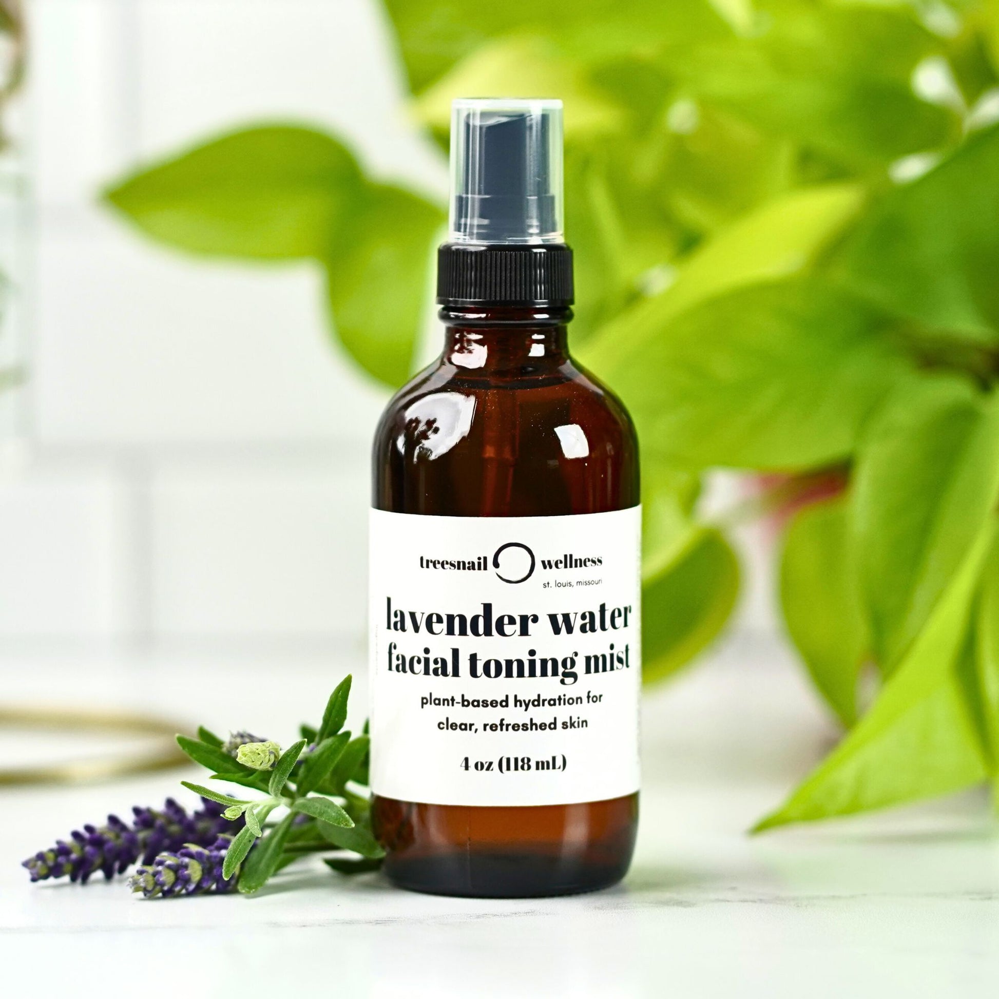 Bottle of lavender water facial toning mist with a plant in the background