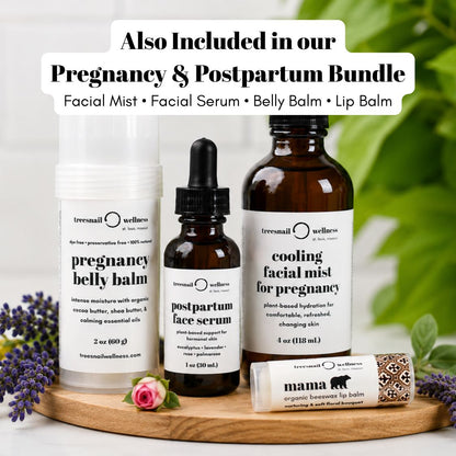 A product bundle display featuring Treenail Wellness skincare items: a white bottle of pregnancy belly balm, an amber dropper bottle of postpartum face serum, an amber bottle of cooling facial mist for pregnancy, and a white tube of Mama Organic Beamer Lip Balm, arranged on a wooden tray with decorative flowers and green leaves.