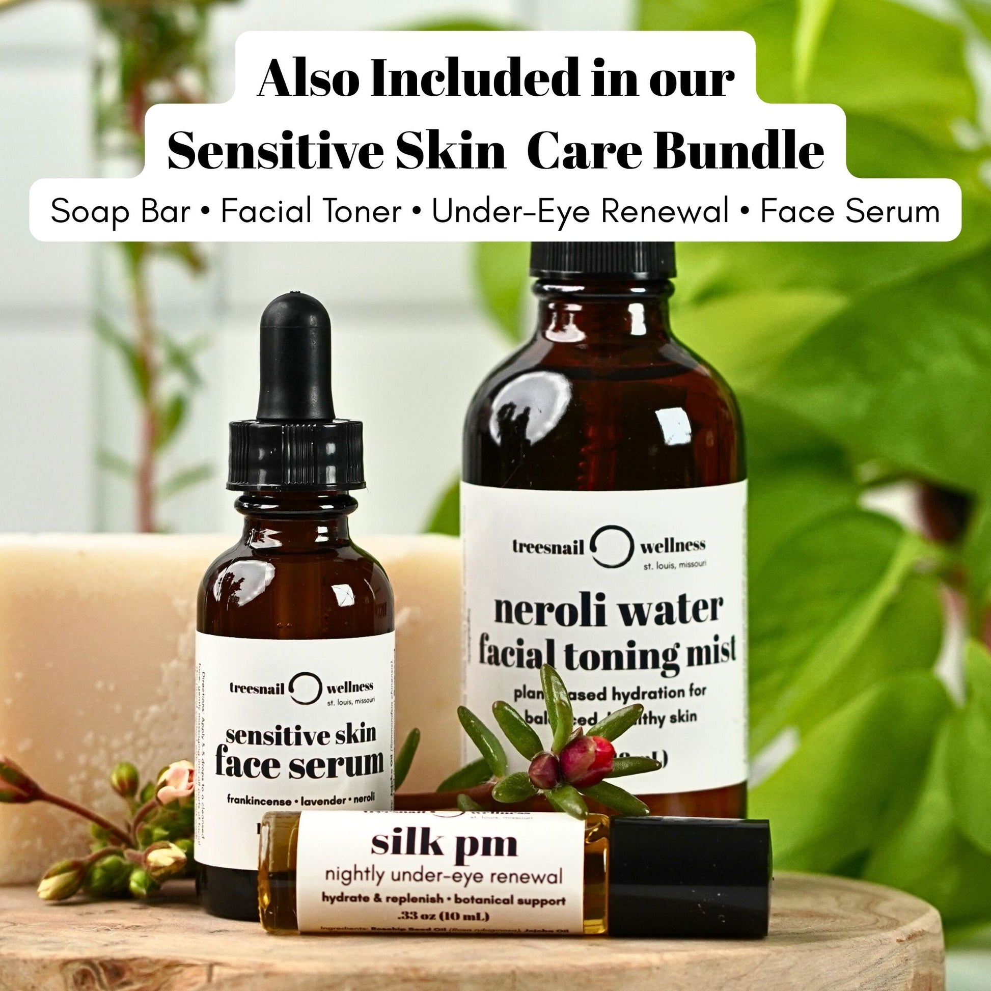 Treesnail Wellness skincare products including a fragrance free soap bar, sensitive skin face serum, neroli water toning mist, and under eye renewal on a wooden surface with a blurred green background.