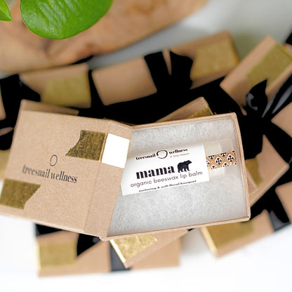 Ten organic .15 oz lip balms—each individually boxed with black satin ribbon, assorted essential-oil scents