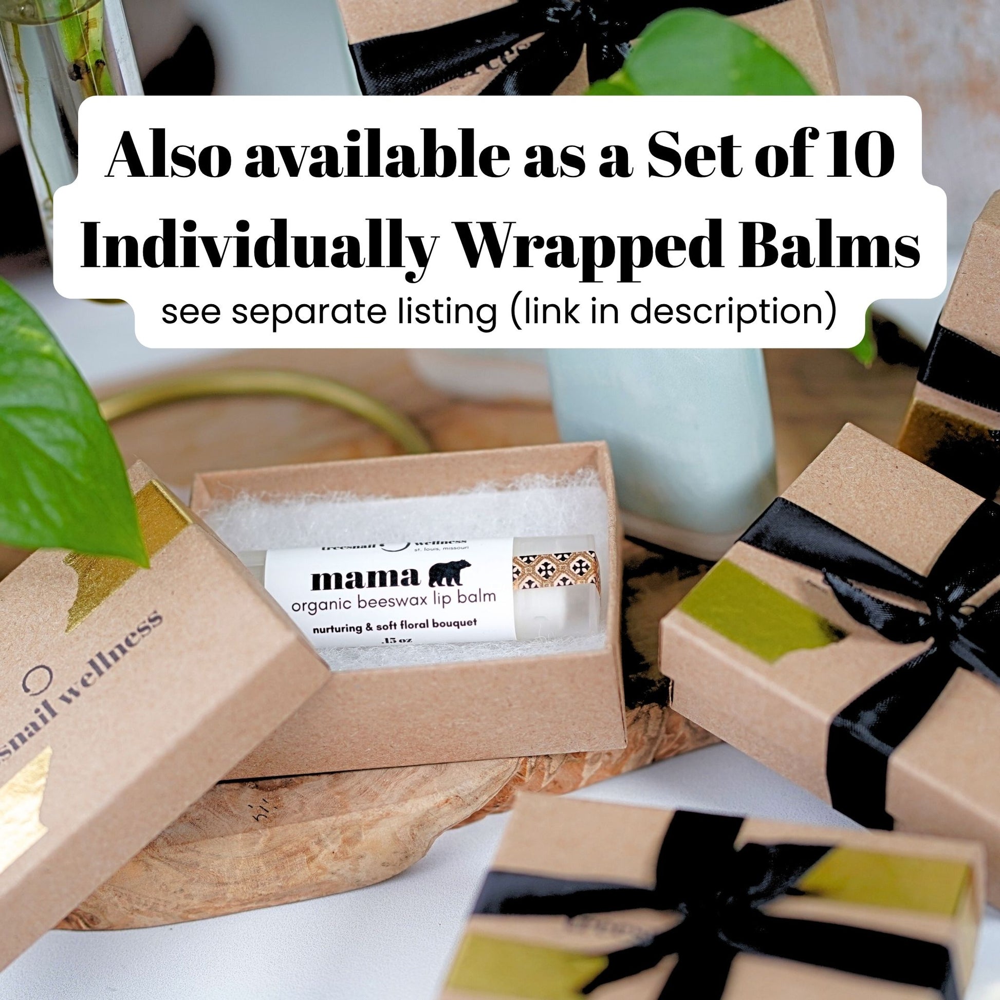 Set of individually wrapped lip balms in brown boxes with black ribbons on a white surface.