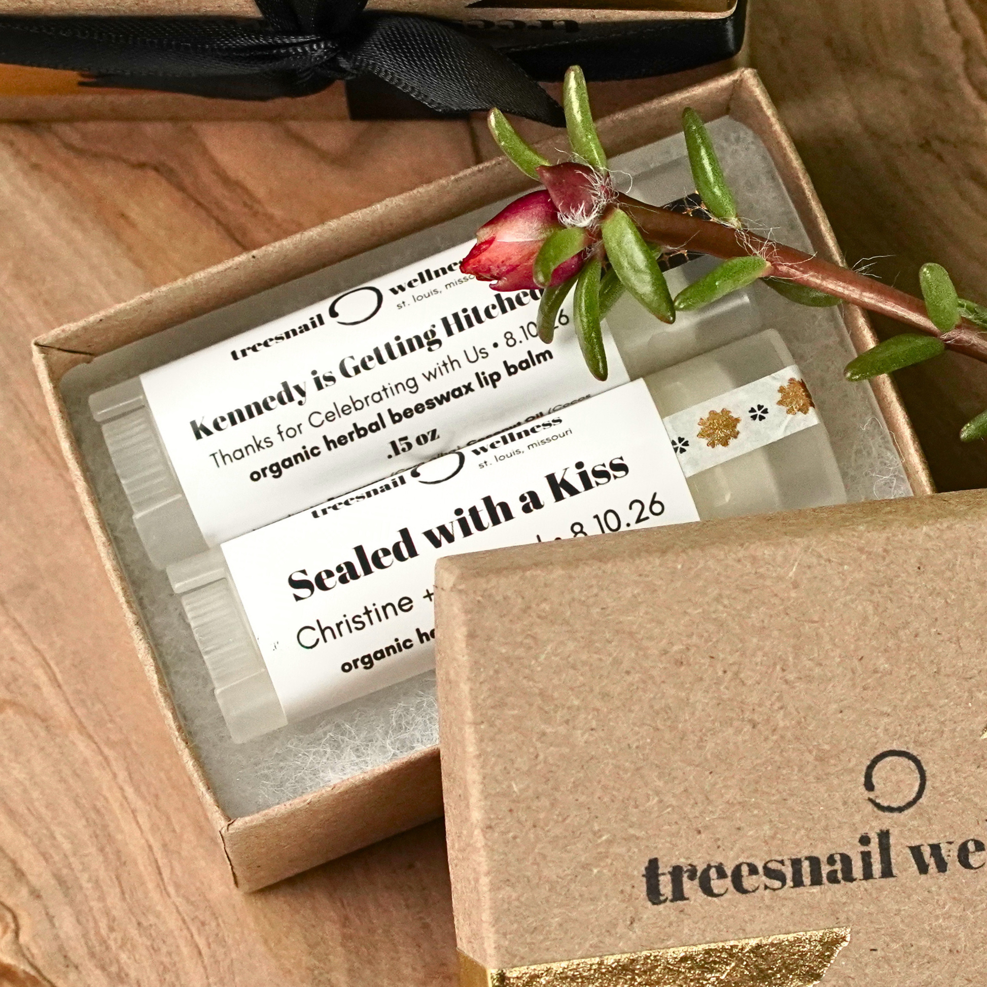 Lip balm with personalized bridal shower labels in a sustainable box, featuring the brand 'treesnail wellness'.