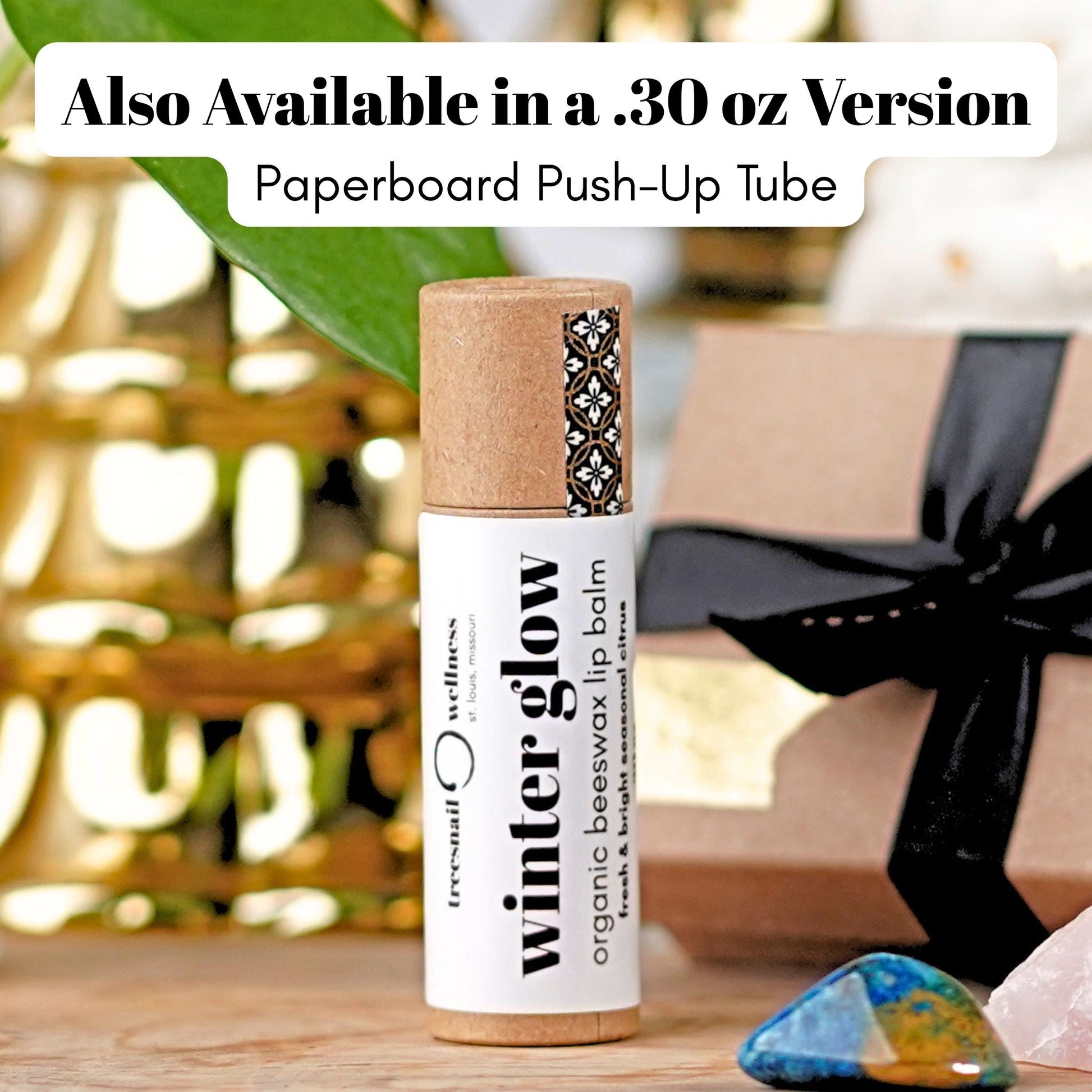 Winter Glow eco-tube lip balm .30 oz paperboard push-up—grapefruit, orange, frankincense, balsam fir, ginger (seasonal Oct–Dec)