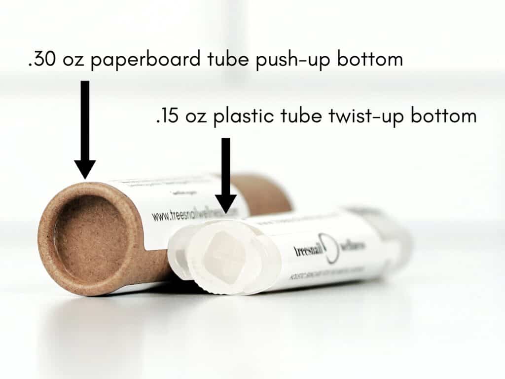Two lip balm tubes, one paperboard and one plastic, with labels indicating their respective sizes and features.
